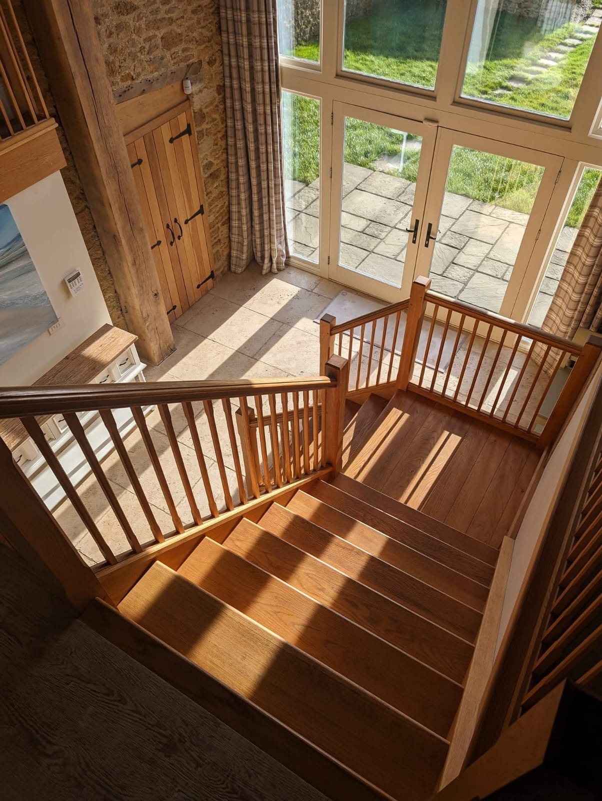 Oak staircase and patio doors in a barn conversion