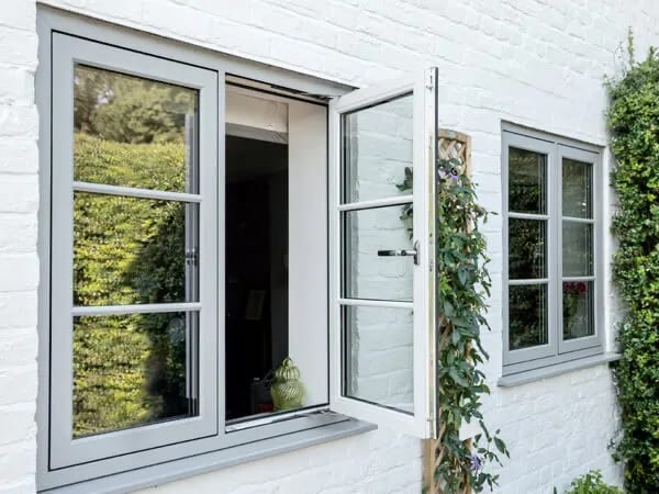Freshly cleaned grey-framed windows on a white house